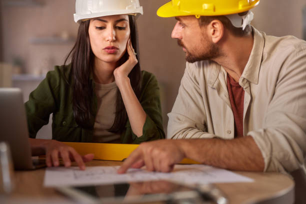 istock Young architects working on blueprints in the office. 2162069515