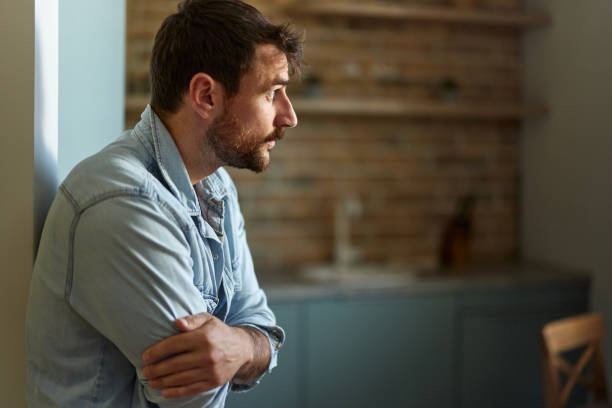istock Worried man thinking of his problems at home. 2162069637