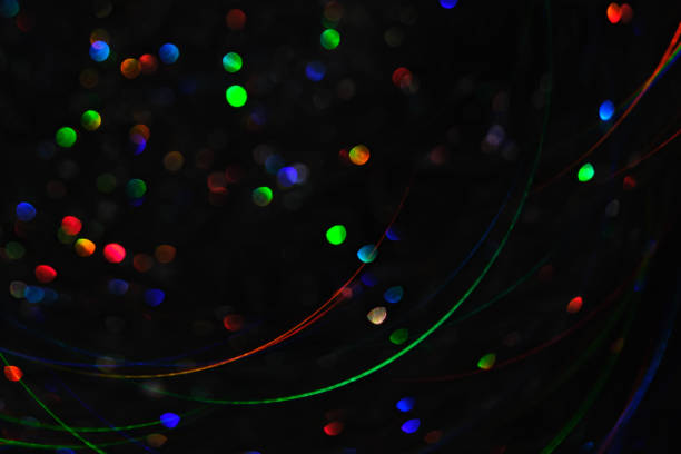Abstract black background with bokeh of different colors. High quality photo.