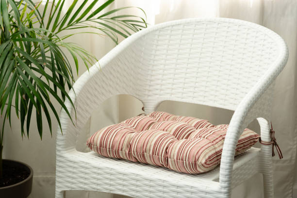 White Wicker Patio Chair With Cushion In Home Setting Close Up