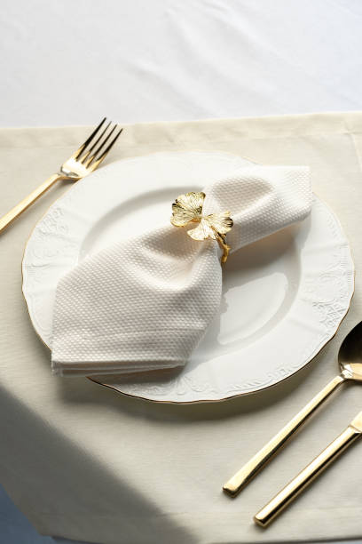 istock Gold Leaf Napkin Ring on White Plate and Placemat 2162070142