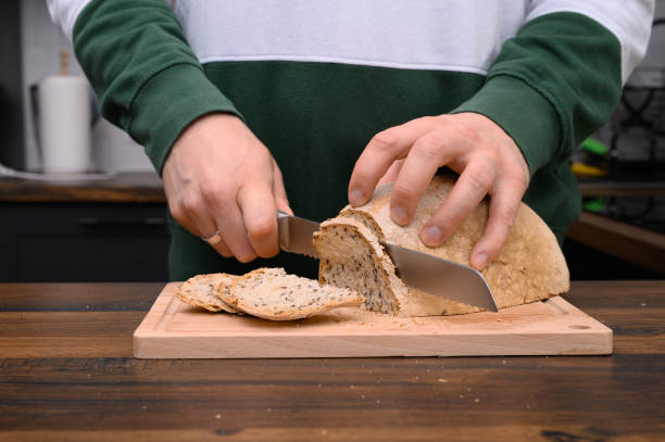 istock Slicing spelled bread on rye sourdough on a cutting board close-up 2162071930