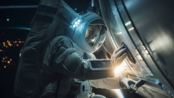 istock Caucasian Astronaut Performing Routine Maintenance Check Outside a Spacecraft in Weightless Zero Gravity in Outer Space. Advanced Space Technology, Scientific Exploration, Female Empowerment Concept 2162076813