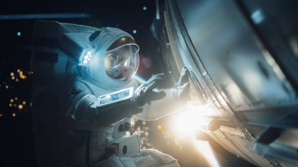 istock Professional Astronaut Performing a Routine Maintenance Check Outside a Spacecraft in Zero Gravity in Outer Space. Advanced Space Technology, Scientific Exploration, Female Empowerment Concept 2162077059
