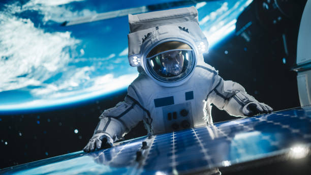 istock Astronaut on an Extravehicular Mission in Outer Space Far From Planet Earth. Courageous Man Fixing and Adjusting the Angle on a Solar Panel Module Outside the Space Station During a Service Work 2162077140