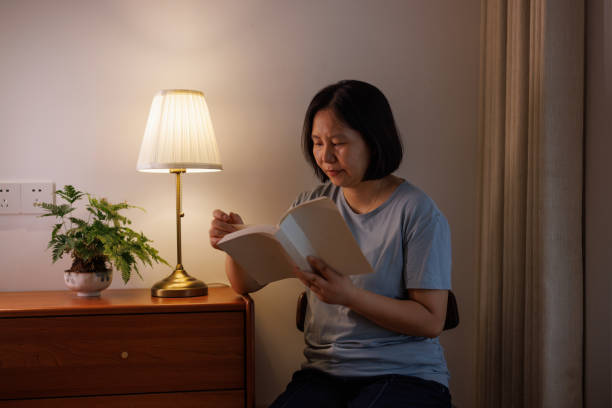 istock Happy Asian woman reading at home 2162077607