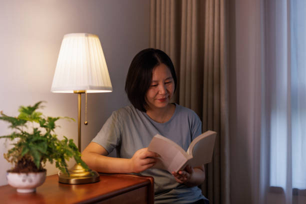 istock A woman is reading at home 2162077609