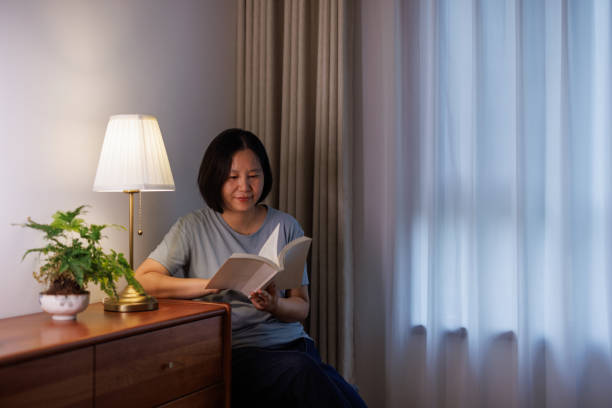 istock Happy woman reading at home 2162077612