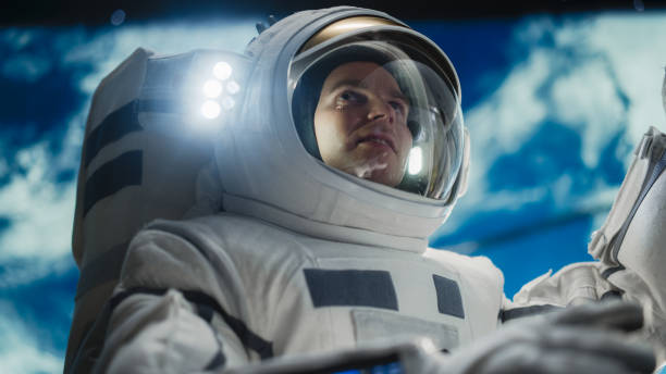 istock Portrait of a Handsome Young Astronaut Investigating a Satellite in Outer Space. Trained Professional in a Space Suit Performing Extravehicular Activity Outside the Advanced Spacecraft 2162077648
