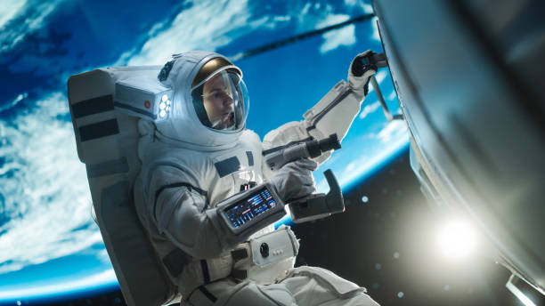 istock Space Technician Mending a Panel on an International Space Station with an Automatic Screw Gun. Fearless Astronaut Working in Outer Space with Gorgeous Blue Planet in the Background 2162077673