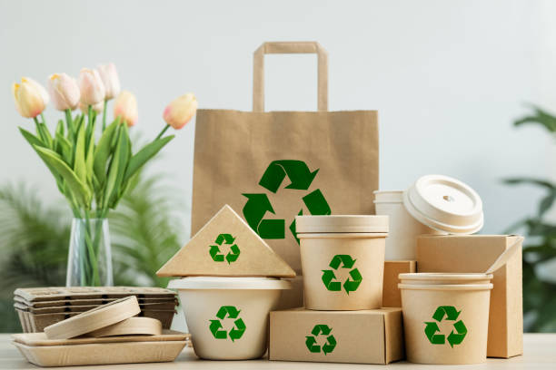 istock Use of eco-friendly paper tableware and packaging made from biodegradable materials. Set of eco friendly food packaging with recycling symbols on table white background. 2162078484