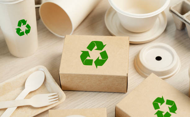 istock Use of eco-friendly paper tableware and packaging made from biodegradable materials. Set of eco friendly food packaging with recycling symbols on table white background. 2162078494