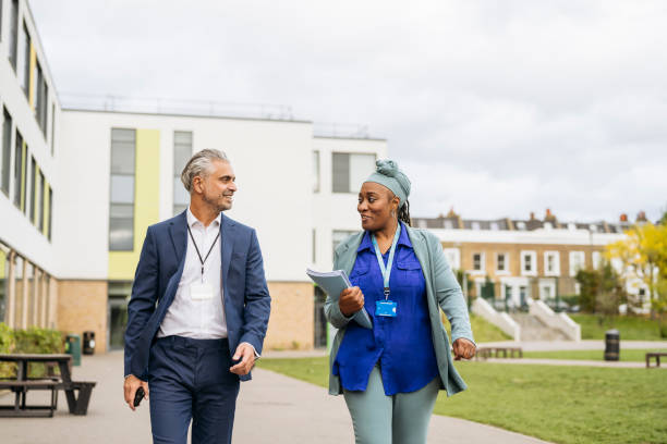 istock Teacher and exam supervisor walking to class 2162080822