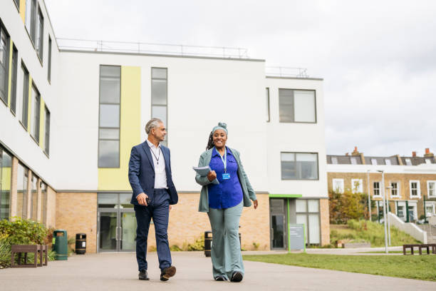 istock Secondary school teacher and administrator on campus 2162080826
