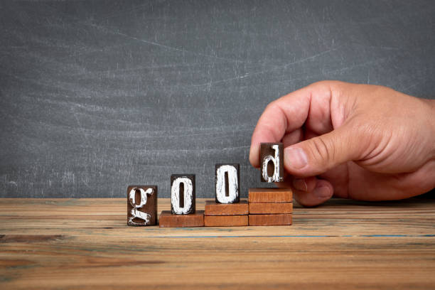 istock GOOD. Wooden letters, alphabet blocks on steps. development and growth concept 2162081171