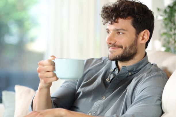 istock Happy man drinking coffee in a house interior 2162081373