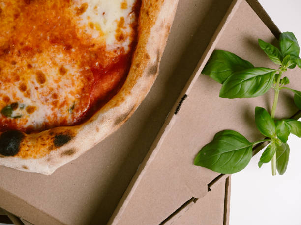Fresh Neapolitan Pizza Margherita in a cardboard box for delivery