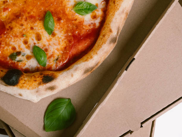 Fresh Neapolitan Pizza Margherita in a cardboard box for delivery