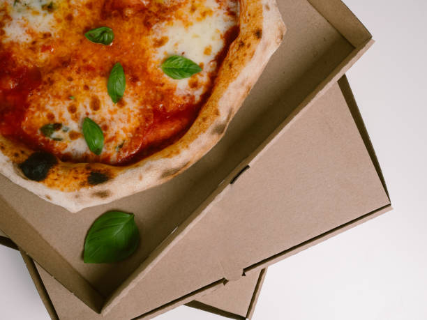 Fresh Neapolitan Pizza Margherita in a cardboard box for delivery