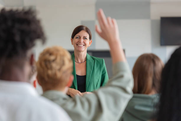 Female teacher giving presentation to university students