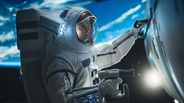 istock Portrait of Engineer Servicing a Panel on a Communication Satellite with an Automatic Screw Gun in Open Space. Professional Astronaut Working in Space with Beautiful Planet Earth in Background 2162084417