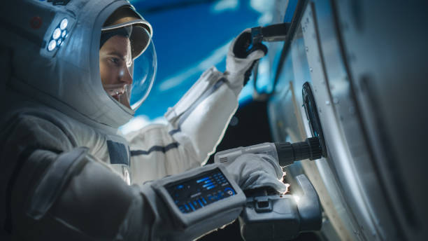 istock Portrait of Engineer Servicing a Panel on a Communication Satellite with an Automatic Screw Gun in Open Space. Professional Astronaut Working in Outer Space with Beautiful Planet Earth in Background 2162084438