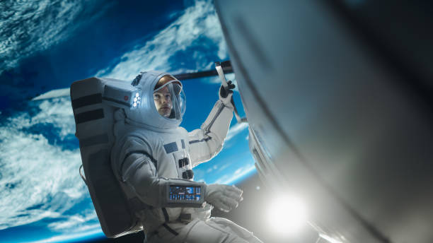 istock Portrait of Handsome Young Astronaut Investigating a Satellite in Outer Space. Trained Professional in a Space Suit Performing Extravehicular Activity Outside the Advanced Spacecraft 2162084528