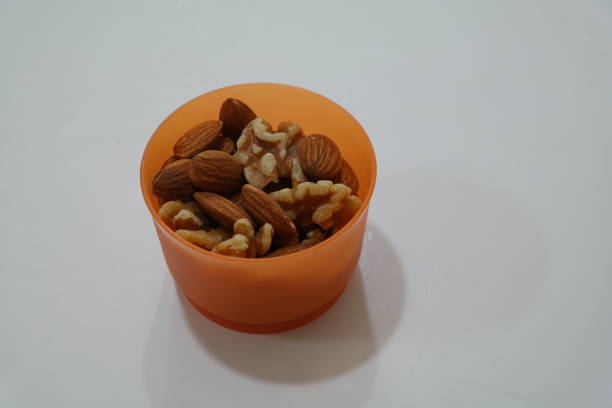 Hazelnuts and almonds with rosemary and thyme, about to be blanched.