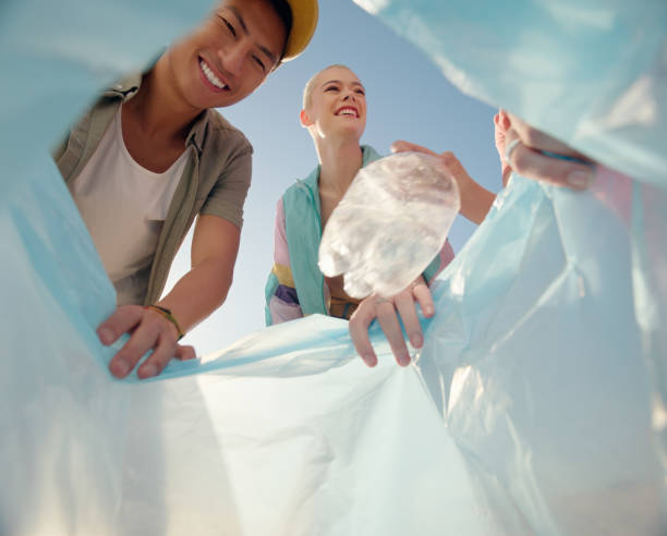 istock Plastic, bottle and people volunteering for cleaning, environment and helping or support in low angle outdoor. Portrait of friends or group with recycling bag and plastic for NGO project or teamwork 2162086253