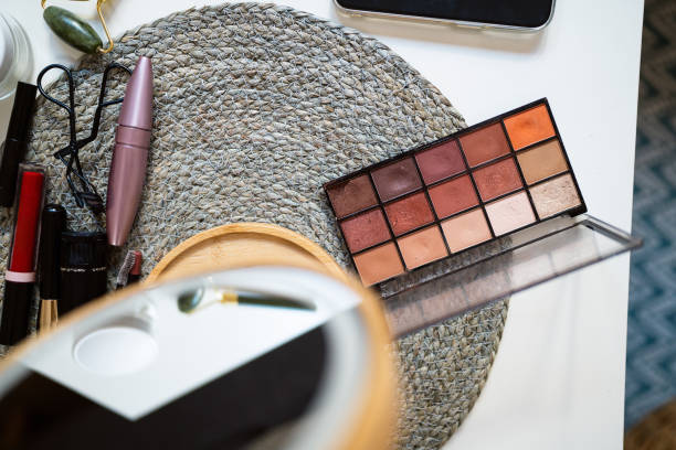 High-angle view of an makeup products and mirror on a coffee table