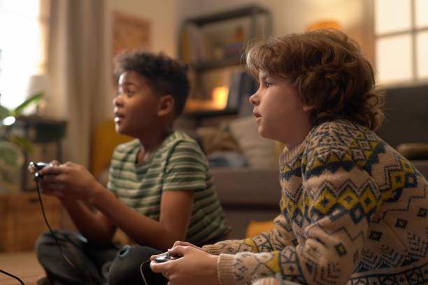 istock Enthusiastic Multiethnic Boys Playing Retro Video Game Together 2162086494
