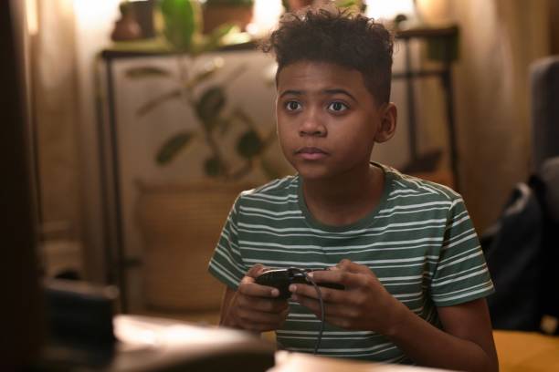 istock African American Boy Playing Retro Video Game 2162086503