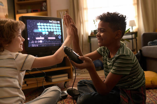 istock Kids High-Fiving While Playing Video Games 2162086514