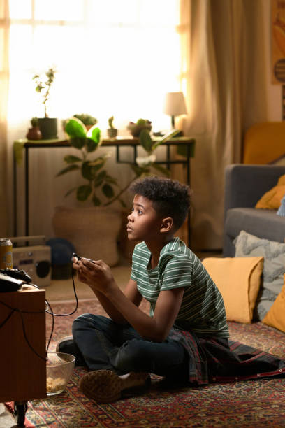 istock Boy Playing Video Game Concentrating on TV Screen 2162086536