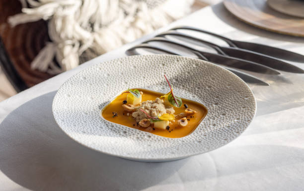 Elegant Restaurant Michelin desert plate with deconstructed mango and pineapple crumble cake in elegant fine dining restaurant