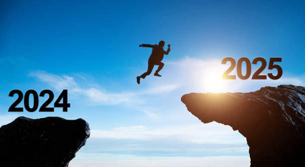 istock Single businessman jumping from 2024 cliff to 2025 2162094761