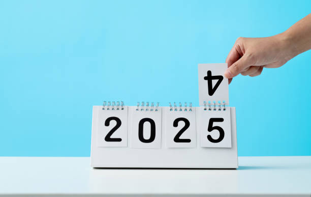 Hand holding calendar sheets 2024 change to 2025
