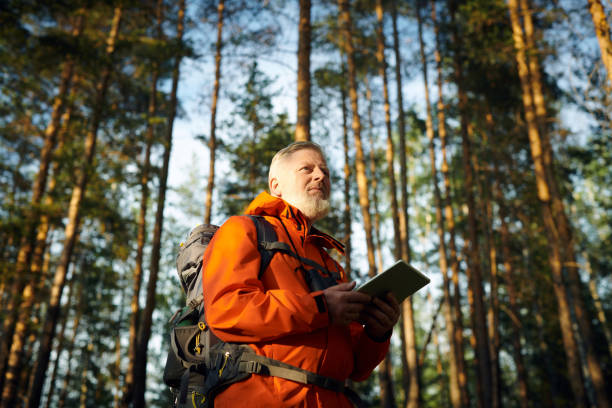 istock Senior Man With Digital Tablet In Forest 2162094845