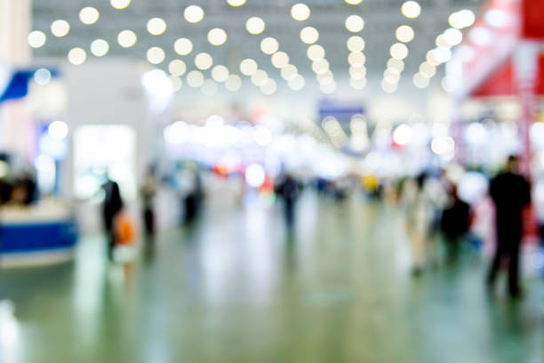 istock Abstract defocused crowd of people walking in exhibition 2162094947