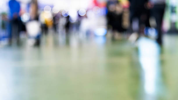 Abstract defocused crowd of people walking in exhibition