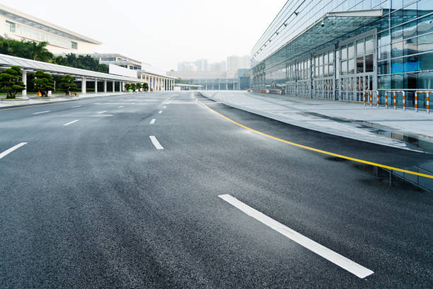 Asphalt road to modern office building.