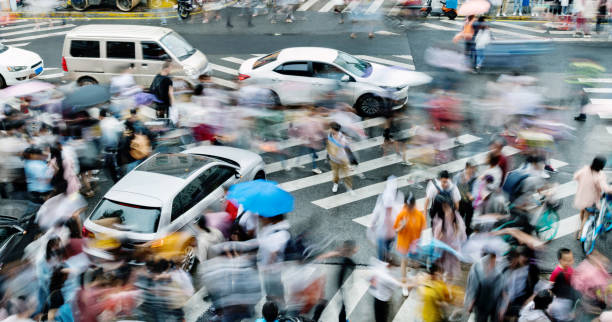 istock Motion blurred people and cars on the sidewalk 2162095132