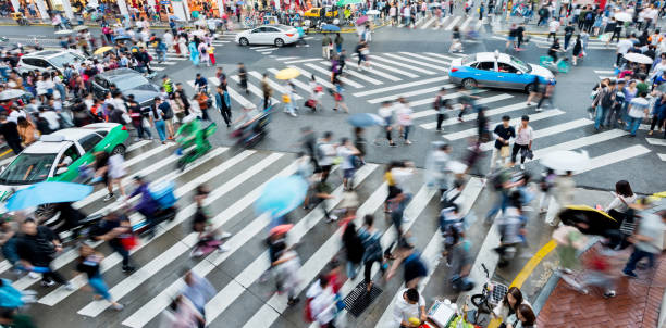 istock Motion blurred people and cars on the sidewalk 2162095135