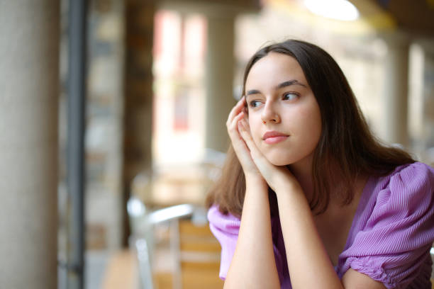 istock Pensive woman dreaming in a cofee shop terrace 2162096721