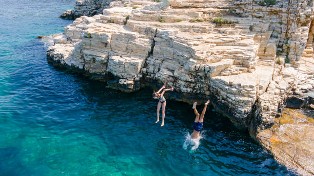 istock Children jumping into sea 2162097238