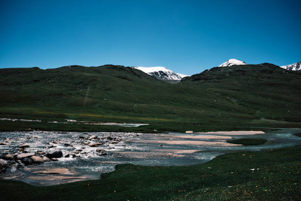istock White frozen mountain ridge above stunning mountain river valley 2162098592
