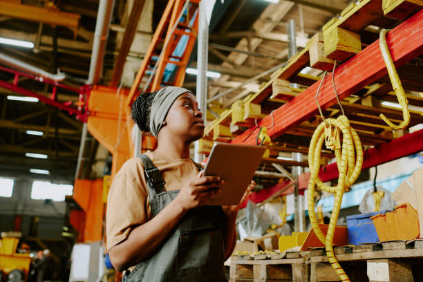 istock Black Woman Using Digital Tablet At Work In Factory 2162099246