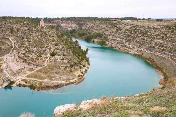 The historic Torre de Alarconcillo surrounded by the Jucar River in Alarcon town, Cuenca, Spain