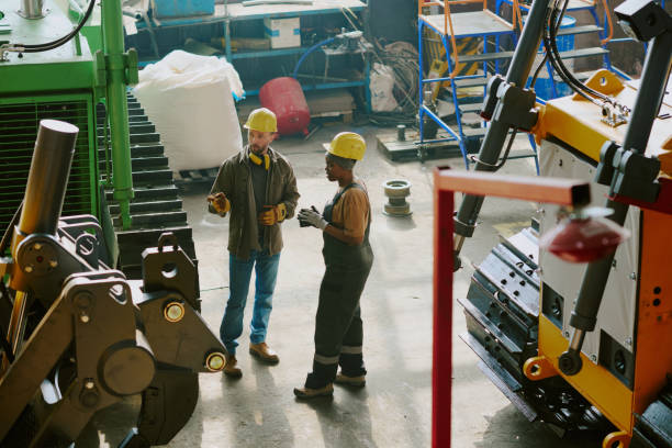 istock Two Diverse Colleagues Discussing Issue At Work In Factory 2162100606