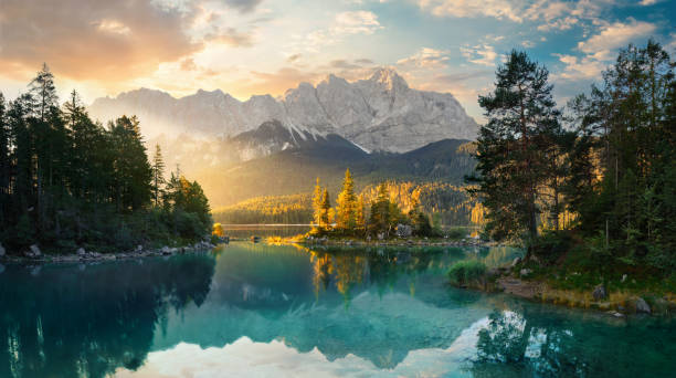 Painterly lake scenery with mountains and a ray of light